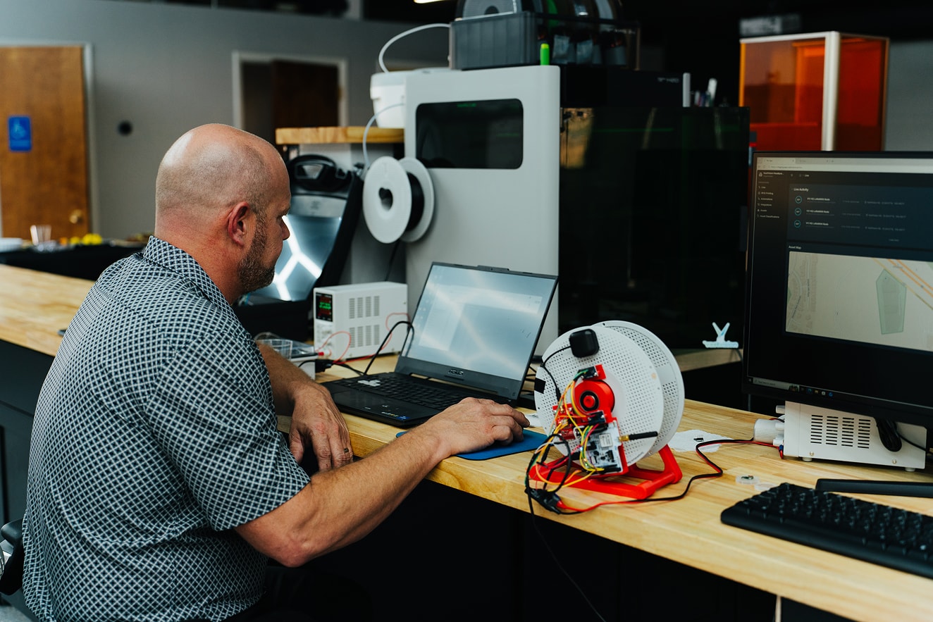 An engineer testing a rotational sensor on a cable spool